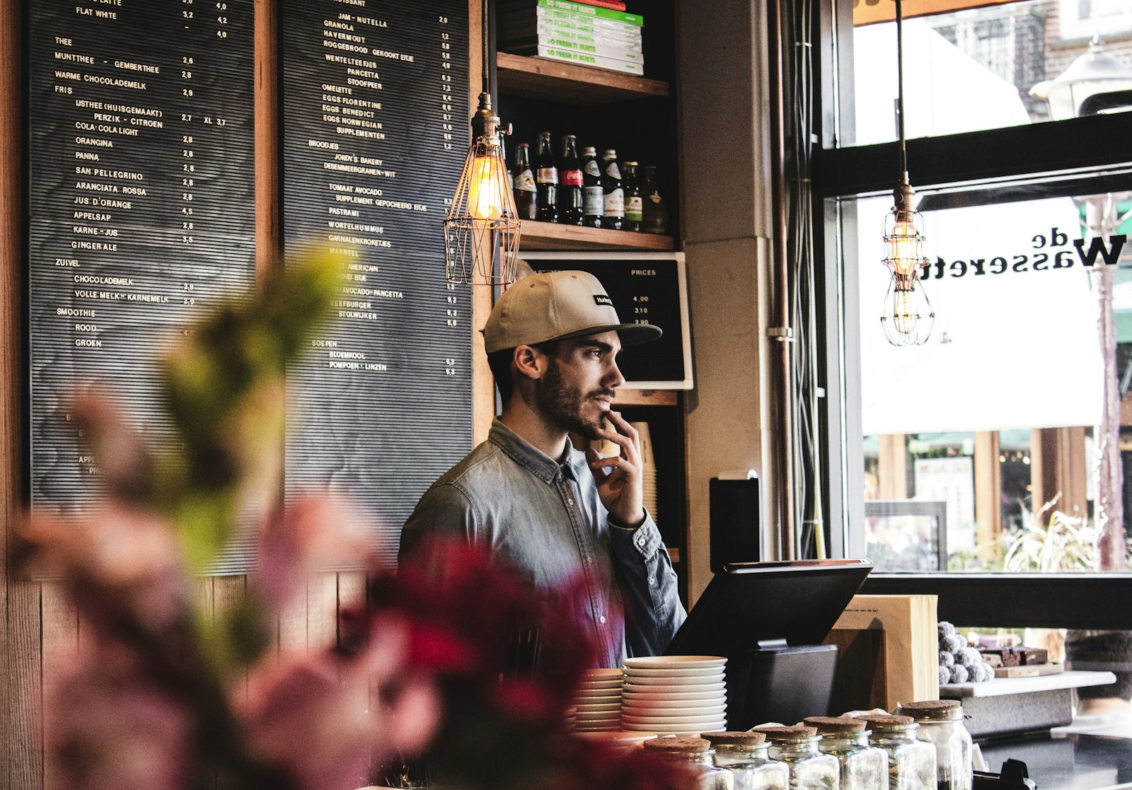 Business owner handing a product to a smiling customer at the counter